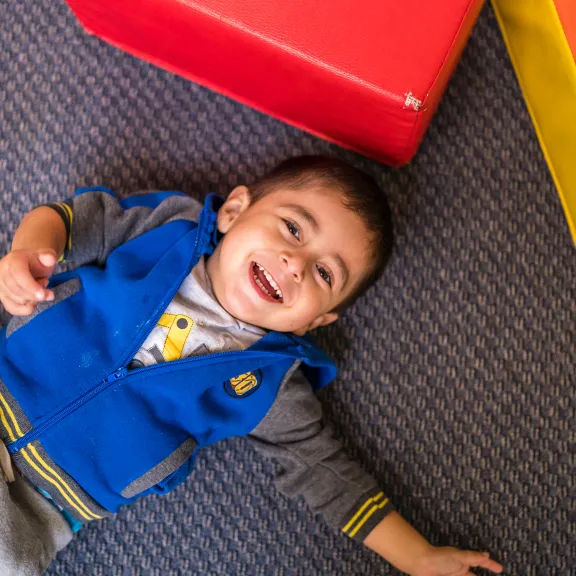 Little boy laying on ground