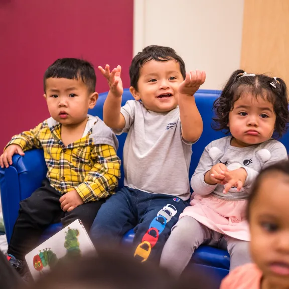 Babies sitting on little sofa