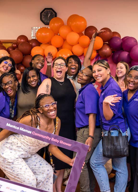 MCC workers smiling together at the montco mamas baby shower 