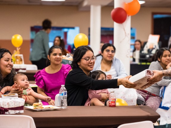 Pregnant people sitting around a table