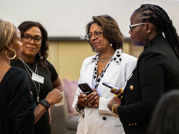 four women talking with each other 