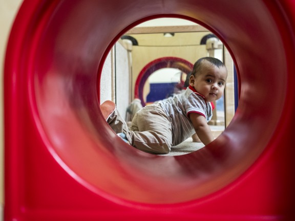 Child in play red play tunnel