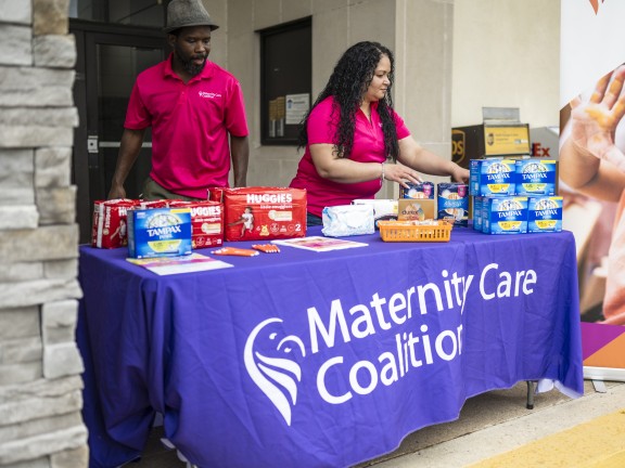 woman and man fixing menstrual products on the table