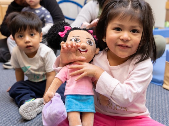 little girl holding a teddy bear