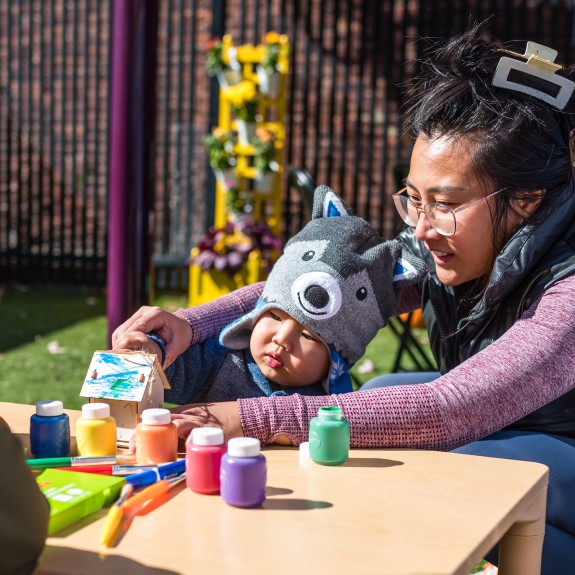 Mom and child outside painting