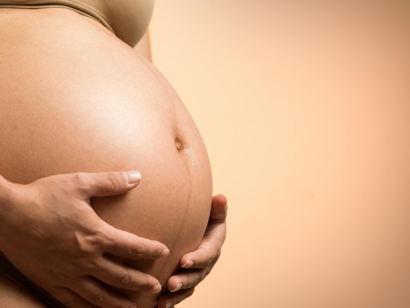woman holding pregnant belly
