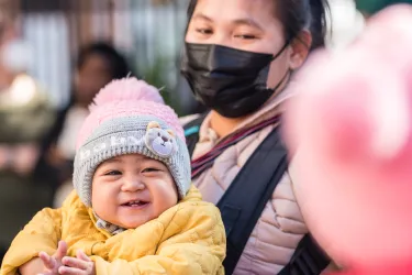 Mom in mask with baby