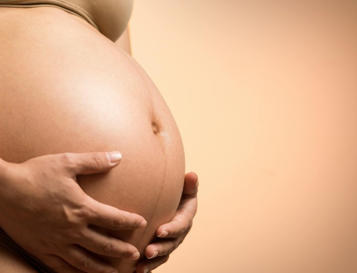woman holding pregnant belly