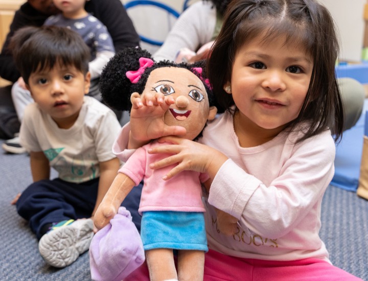 little girl holding a teddy bear 